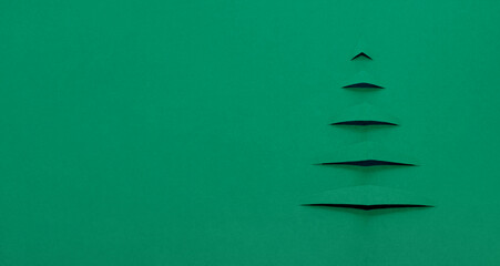 Creative Christmas tree cut out of green paper.Creative Christmas and New Year background.Copy...