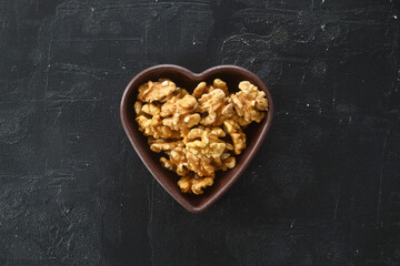 Inshell walnuts in a heart-shaped plate. Heart Nuts, Heart Health Products, Structured Walnuts Healthy food protein