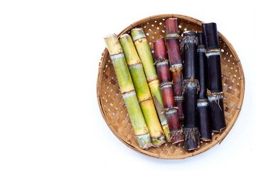 Sugar cane in bamboo basket on white background.