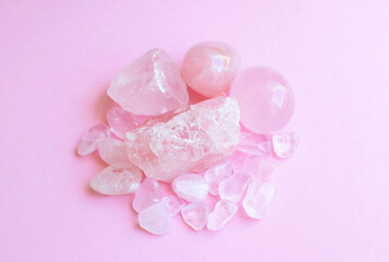 Obraz na płótnie Canvas Crystals of rose quartz on a pink background. Beautiful semi-precious stones
