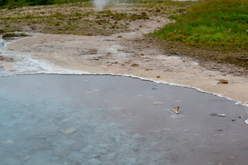 Landscape of steamy hot springs at Geysir Golden Circle Iceland
