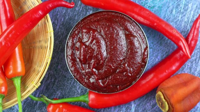 Korean pepper paste and red pepper in wooden plate, Gochujang Korean traditionl Chili paste on a wooden table background. 4K