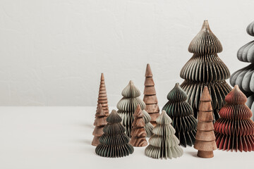 Scandinavian christmas paper and wooden xmas trees. Modern christmas decoration, minimalist and plastic free