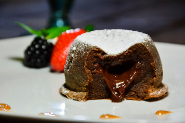 small chocolate flavor cake filled with the same flavor named volcano
