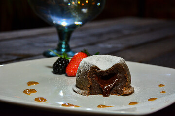 small chocolate flavor cake filled with the same flavor named volcano