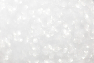 Defocused christmas or party, grey glitter background with bokeh. Holiday glowing backdrop,banner or card.
