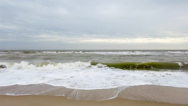 Minimalisticand sea landscape with waves and moode sky