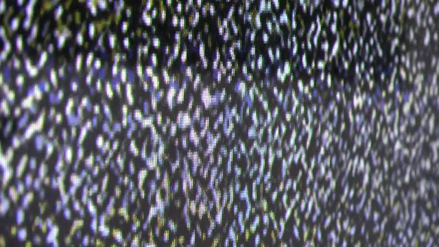 Perspective close up view at a plasma tv while showing television activity.