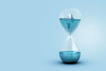 Zelfklevend Fotobehang Greenland glacier melting and global warming concept. Iceberg melting in a glass hourglass, time and the rising temperature of planet Earth. Creative idea. Heightening worldwide flood risks © alones