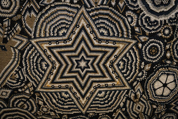 2021-11-02 A ABSTRACT BEADED STAR DESIGN IN BLACK WHITE AND LIGHT BROWN 