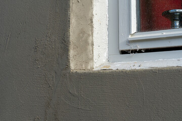 Styrofoam insulation sheets on house facade wall for thermal protection with mortar.