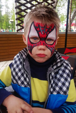 Boy With Spiderman Pattern On His Face