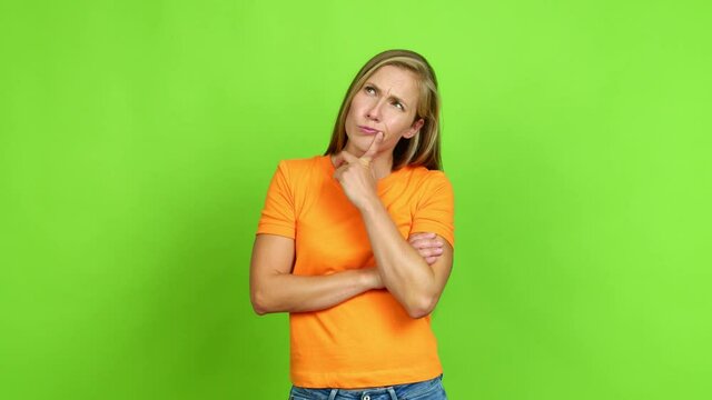 Young blonde girl having doubts and questioning an idea over isolated background. Green screen chroma key
