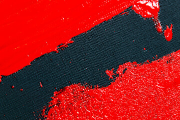 abstract creative background: red spots, strokes and splashes of colored primer when toning a black canvas, a temporary object.