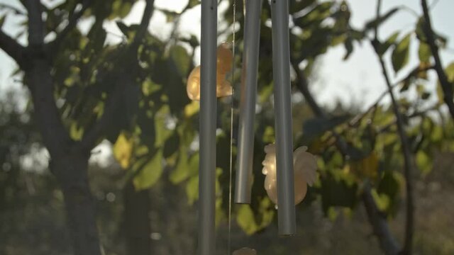 Wind chimes moving in the wind with toys in the garden