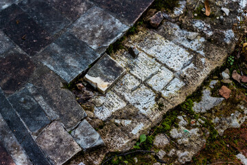 Texture of old broken marble tiles on the street