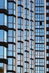 Obraz premium a fragment of the glass facade of a multi-storey building under construction