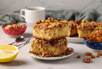 Homemade lemon pie with raisins and nuts on a light gray background, Close-up