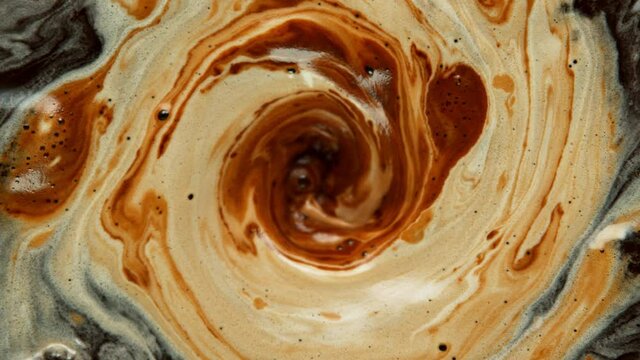 Super slow motion Shot of Swirling Coffee and Cream at 1000 fps.
