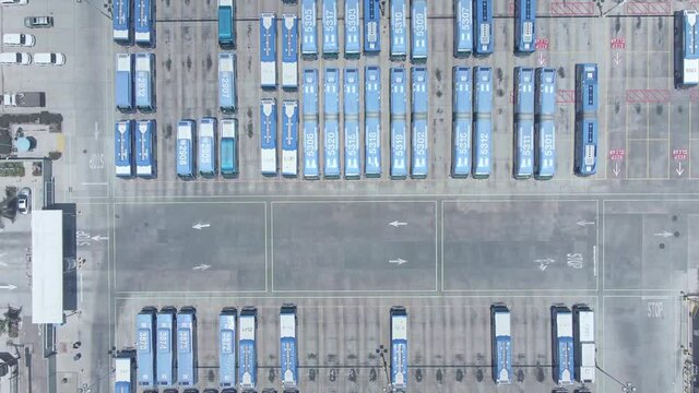 Aerial view of bus terminal in Los Angeles. top-down view of bus hub, public transportation in USA. Transfer station, commuter life in American city. 