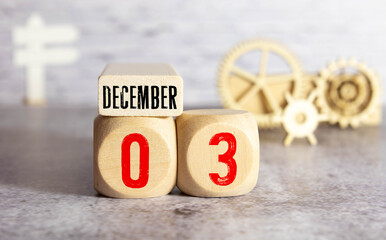 December 3rd, 3 December, Third of December - White block calendar on vintage table - Date on dark background.