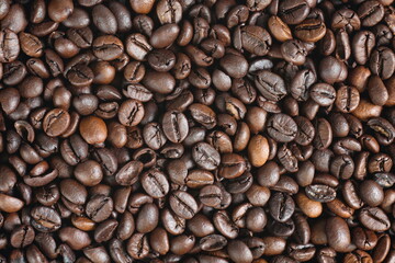Dark roasted Robusta coffee beans with close up shot,top view.