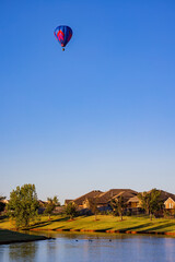 Hot air balloon flying over a community
