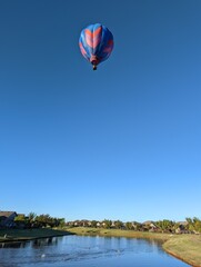 Hot air balloon flying over a community