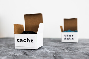 online privacy and stored information, metaphor of open boxes with User data and Cache labels next to each other © faithie