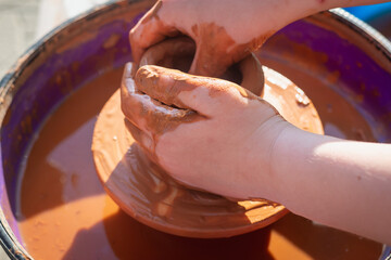 Working with red clay. Clay crockery making.