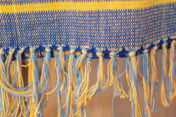 Colored knitted scarf with hanging tassels.