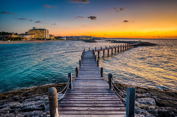 Sunset in Okinawa, Japan, taken at Onna Son, on a raised wooden jetty linking artificial islands in...