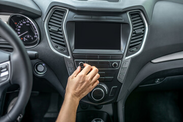 Womans hand touching dashboard in car
