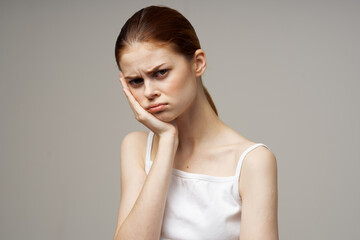 woman in white t-shirt dentistry dental pain close-up light background