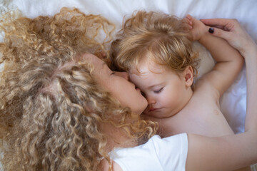 Young mother and baby child sleeping together. Dreams and kids sleep.