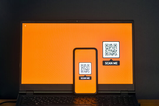 Laptop and smartphone with a QR-code on the screen