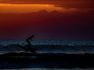 Surfing at Sunset. Outdoor Active Lifestyle.