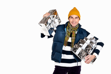Handsome smiling man with new year gifts on white background