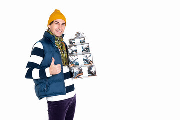 Handsome smiling man with new year gifts on white background