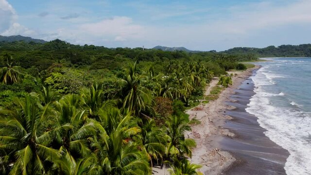 Beautiful Costarica beach Aerial view of the idyllic summer tropical landscape with green palm trees, sea coast and white sand