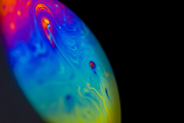 Abstract multicolor psychedelic planet in universe. Closeup soap bubble like an alien planet on...