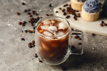 Glass cup of tasty iced coffee on grunge table
