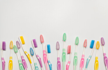 Top view of toothbrushes in colorful on pastel color background.