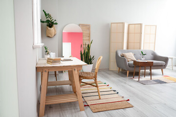 Modern living room interior with stylish mirror, sofa and table