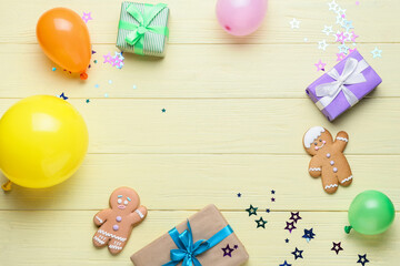 Frame made of balloons, gifts and cookies on color wooden background