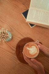 Woman hands  holding cup of coffee with latte art. holding cup of tea or coffee in the morning