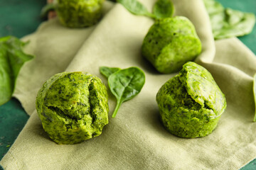 Tasty spinach muffins on table, closeup
