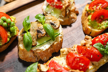 Delicious vegetarian bruschettas on board, closeup
