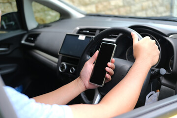 Naklejka premium A guy using mobile phone while driving car