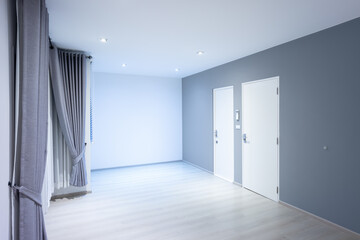 Empty room or bedroom in perspective at night. Interior inside house building with wooden floor or laminate, wall, door, eyelet curtains and  light of downlight. New clean look modern for background.